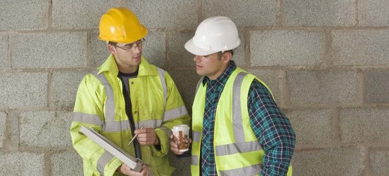 Construction workers with clipboard