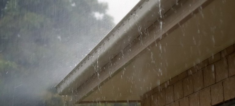 a rain pouring over the gutters