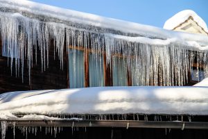 snowy roof and ice in the gutters