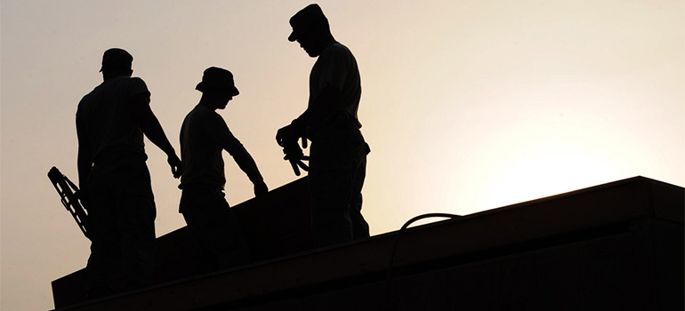 Professional roofers on a roof