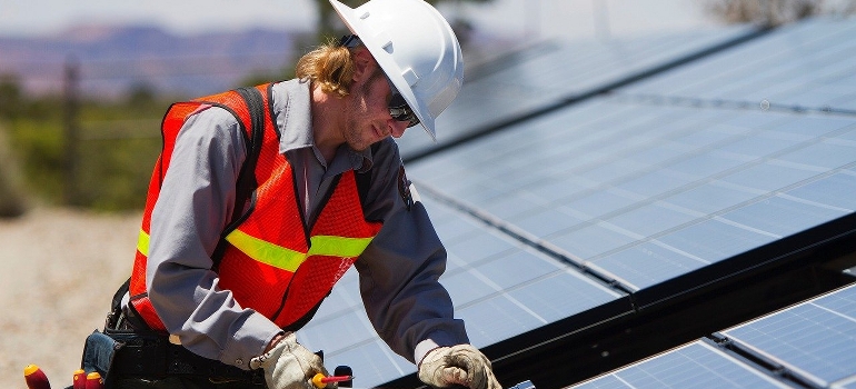 Technician installing solar panel