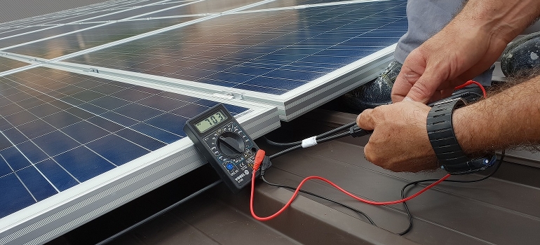 Technician checking solar panel