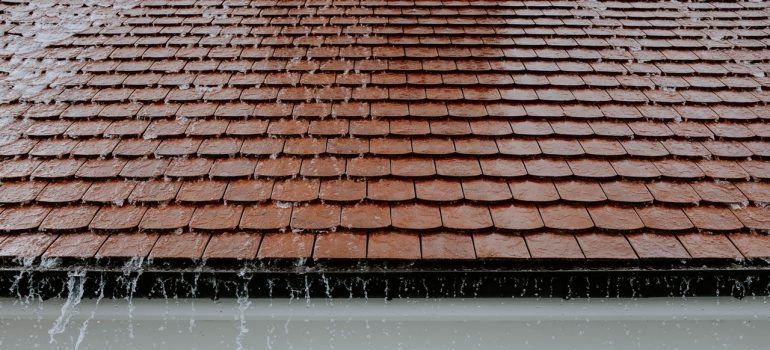 Rain pouring down a roof.